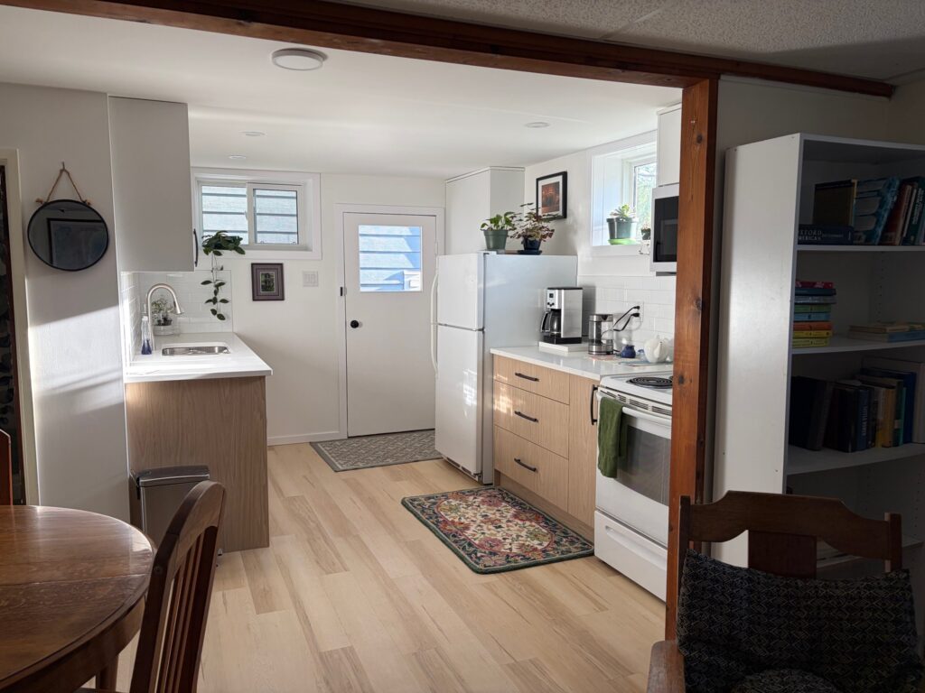 Compact two-tone suite kitchen viewed from the adjoining dining area